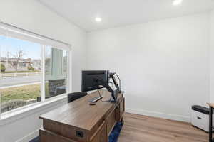 Home office featuring light wood-type flooring and recessed lighting