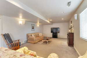 Living room with light colored carpet and recessed lighting