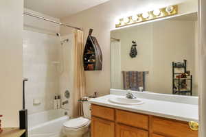 Bathroom with vanity and shower / bath combination with curtain