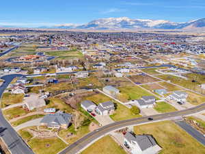 Aerial overview of property's location with nearby suburban area and a mountainous background