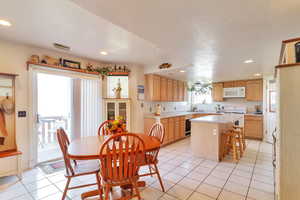 Dining room featuring light tile patterned floors and recessed lighting