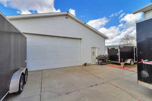 Garage featuring concrete driveway