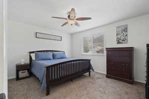 Bedroom featuring light colored carpet and a ceiling fan