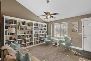 Sitting room featuring ceiling fan, vaulted ceiling, and carpet