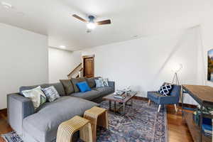 Living room featuring ceiling fan and wood finished floors