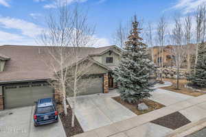 Craftsman inspired home with concrete driveway, roof with shingles, and a garage