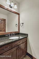 Bathroom featuring vanity and baseboards