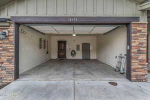 Garage with electric panel and driveway