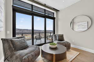 Master bedroom sitting area featuring a mountain view and light wood-style flooring