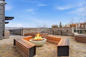 View of patio / terrace featuring an outdoor fire pit at ski pickup area