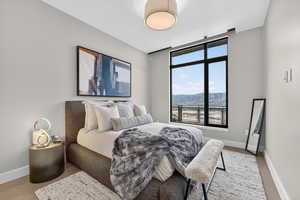 Bedroom featuring a mountain view and baseboards