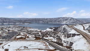 Snowy aerial view with a water and mountain view