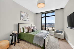 Bedroom with baseboards and light wood finished floors