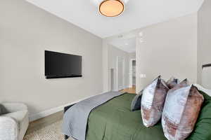 Bedroom with light wood-style floors and a closet