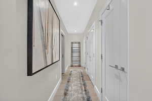 Hallway with recessed lighting and light wood finished floors