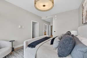 Bedroom featuring ensuite bathroom and light wood finished floors