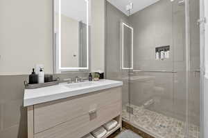 Full bathroom featuring vanity and a stall shower