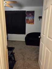 Bedroom featuring dark colored carpet and ceiling fan