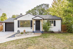 View of front of property with brick siding, a garage, roof with shingles, and concrete driveway