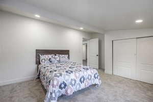 Carpeted bedroom featuring a closet and recessed lighting