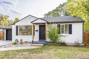 View of front facade featuring brick siding, an attached garage, roof with shingles, and concrete driveway