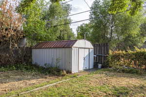 View of shed with a fenced backyard