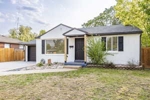 View of front of property with brick siding, an attached garage, driveway, and roof with shingles