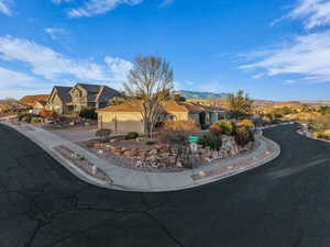 View of front of house with a mountain view and driveway