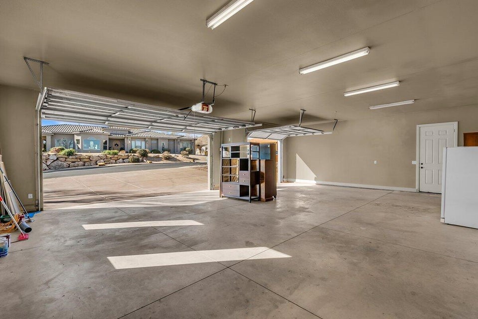 Garage with freestanding refrigerator and baseboards