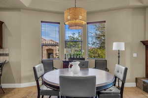 Dining space with baseboards and light tile patterned floors