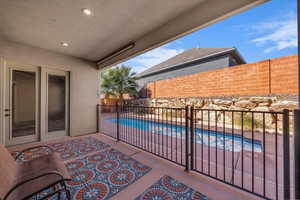 Patio / terrace featuring a fenced backyard, a patio area, and a hot tub