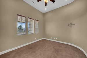 Carpeted spare room with ceiling fan, a high ceiling, and recessed lighting