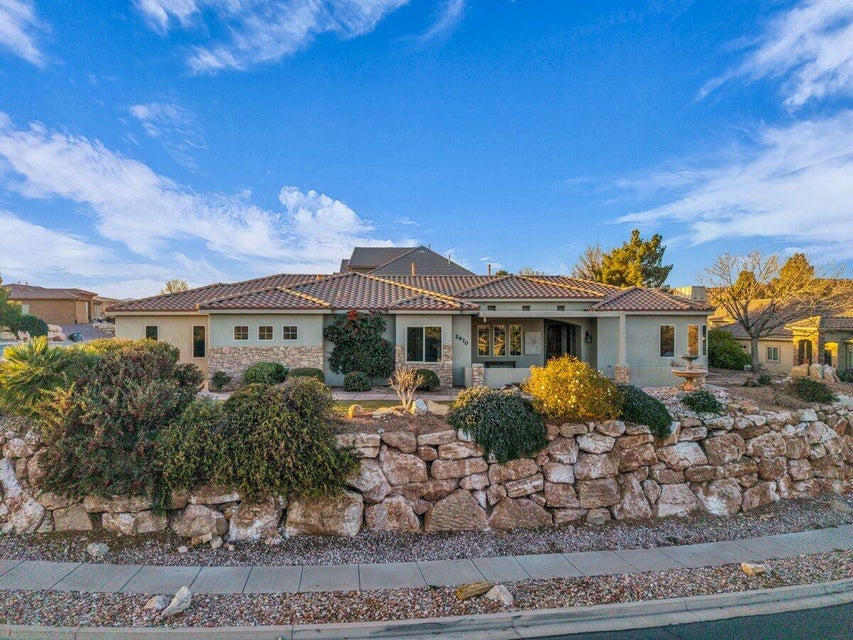 Mediterranean / spanish-style home featuring stucco siding, stone siding, and a tile roof