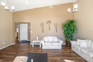 Living room featuring a chandelier and dark wood finished floors