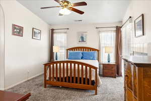 Carpeted bedroom with baseboards and ceiling fan