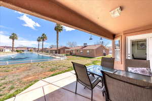 View of patio / terrace featuring a residential view, outdoor dining area, and a water view
