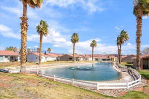 View of swimming pool with a water view and a residential view