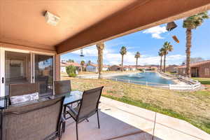 View of patio / terrace featuring outdoor dining space, a residential view, and a water view