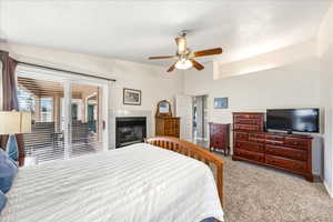 Carpeted bedroom with ceiling fan and access to outside