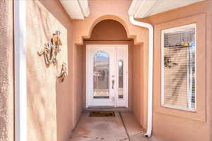 Property entrance featuring stucco siding