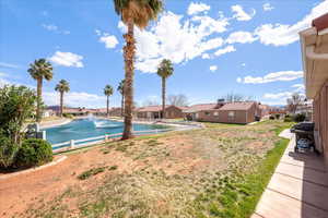 View of pool featuring a residential view, a water view, and area for grilling