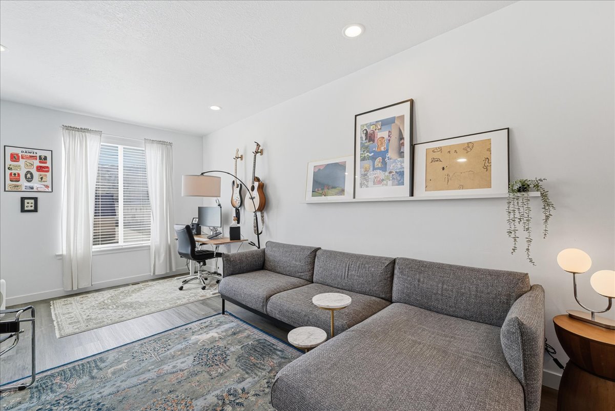 Living area featuring a desk, wood finished floors, and recessed lighting
