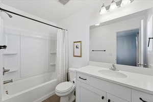 Bathroom featuring vanity and shower / bath combo with shower curtain