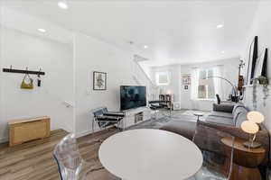 Living area featuring light wood-style floors and recessed lighting