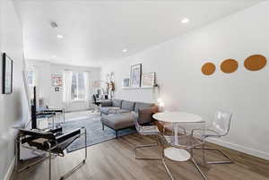 Living room featuring wood finished floors and recessed lighting