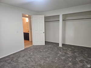 Unfurnished bedroom with multiple closets and carpet floors