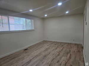 Empty room with wood finished floors and recessed lighting