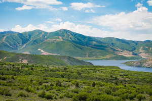 View of mountain backdrop featuring a large body of water