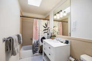 Bathroom featuring a skylight