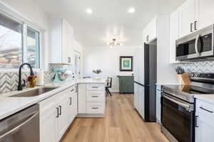 Kitchen with stainless steel appliances and healthy amount of natural light